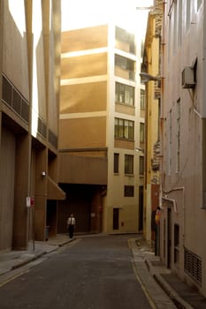 solitary man walikng through an empty backstreet