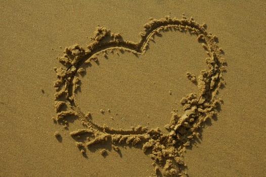 love heart written in sand on a beach
