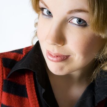 Studio portrait of a young blond curly woman looking interested