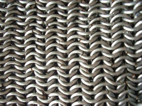 This is the texture of antique chain mail. Of course, it’s a hand-made article. 