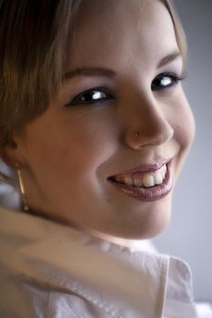 Studio portrait of a young blond curly woman looking attractive