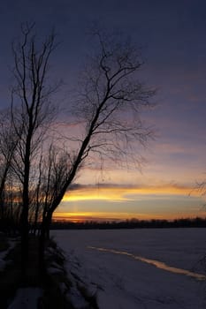 sunset over frozen river