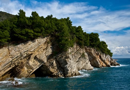 mediterranean coastline with rock and cloudy sky