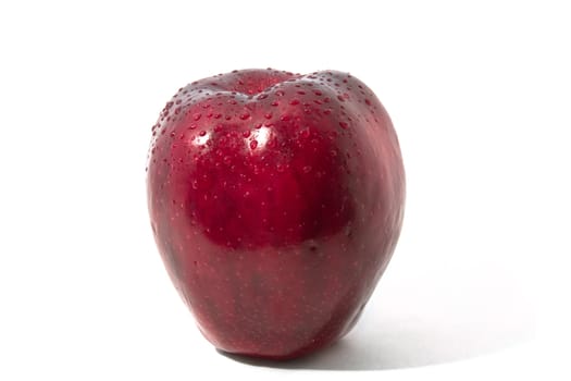 Red apple in drops of water on a white background