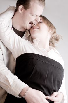 Studio portrait of a young amorous couple fooling