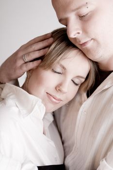Studio portrait of a young amorous couple relaxing