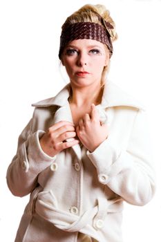 Studio fashion portrait of a young bliond girl looking straight forward