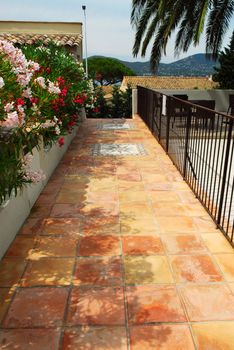 Courtyard of mediterranean villa in French Riviera with ceramic tile walkway