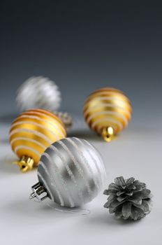 Christmas background with glass bauble ornaments and pine cones