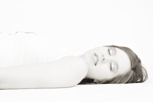 Portrait of a beautiful woman model lying on the studio floor