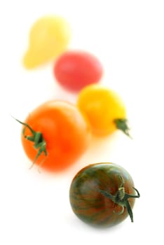 Multicolored cherry tomatoes isolated on white background