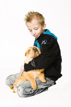 Young boy holding a sleeping sharpei puppy