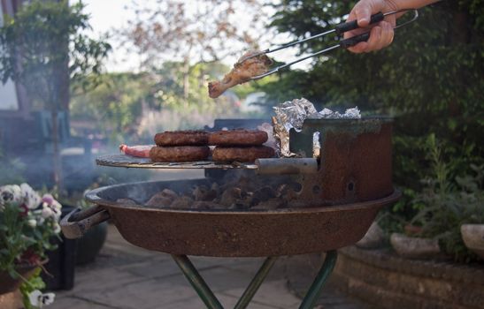 BBQ smokes as mixed meats cook to perfection.