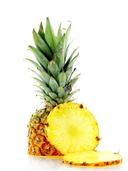 fresh ripe pineapple with slices over white background