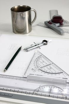technical drawing with mug, pencil, rulers and compass