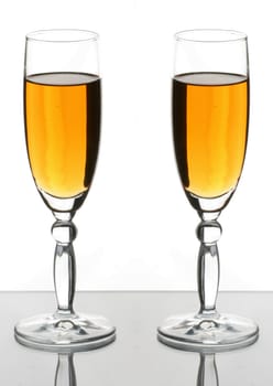 Two wineglass  with white wine on the white background