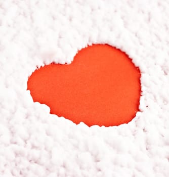 A red heart on the artificial snow background