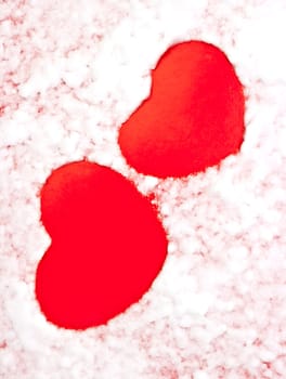 A red heart on the artificial snow background