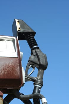 A Gas pump nozzle against blue sky