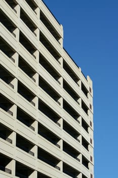 A tall parking deck against blue sky