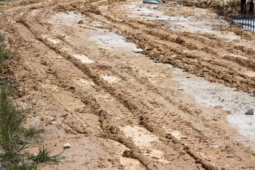 Track formed by trucks driven over it after heavy rain