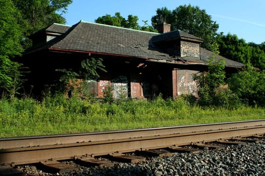A Abandoned train station and railroad tracks