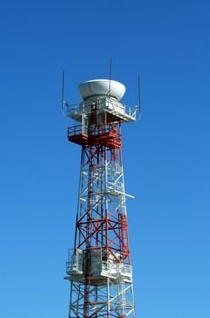 A Airport radar tower with blue sky