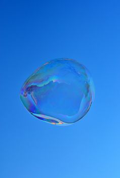 Big bubble flying over blue sky
