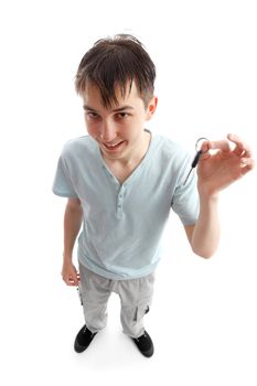 A happy teenage boy holding a key in one hand. Above perspective. White background, 