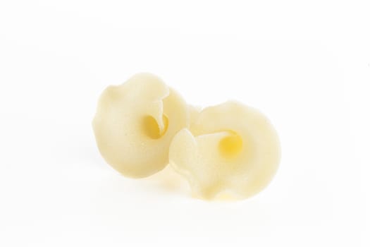 Two pieces of dried gigli pasta isolated on white background.