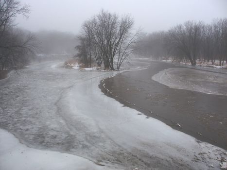 Dense fog over the icy Kishwaukee River in Illinois.
