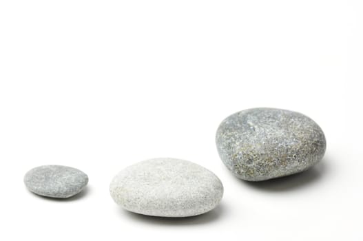 Three pebbles on white background