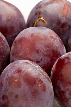 Background of black plums in drying process to become prunes