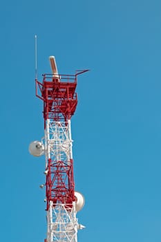 Tall telecomunication tower against blue sky background