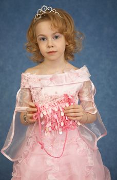 Beautiful girl in pink dress on a blue background