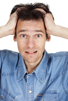 The confused young man has clasped hands a head isolated on white