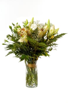 Bouquet of mixed flowers in vase taken on a white background