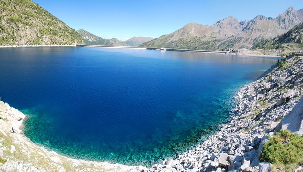 The pure and transparante water of Lake Cap-de-Long  in French Hautes-Pyrenees, At an elevation of 2161 m its 130 deap. Its created by grate dam used for hydroelectric energy station. In the and is a grandiouse dam