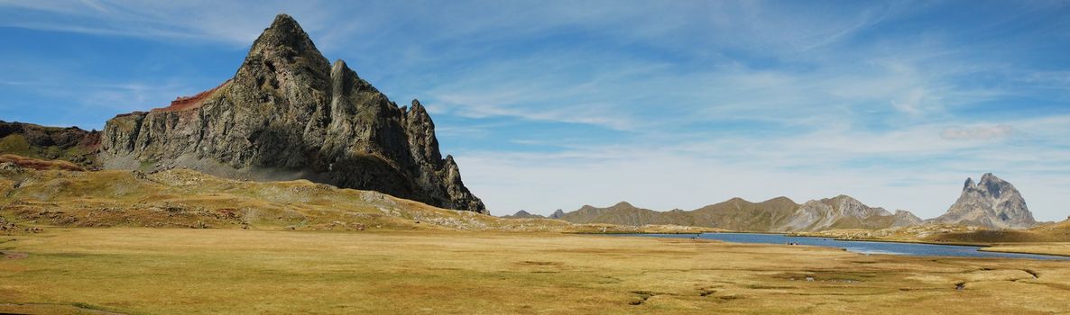 Panorama of Anayet peak in Spanish Aragon and Peak du Midi d'Ossau in French Bearn in Pyrenees mountains, seen from plateau Anayet in summer time