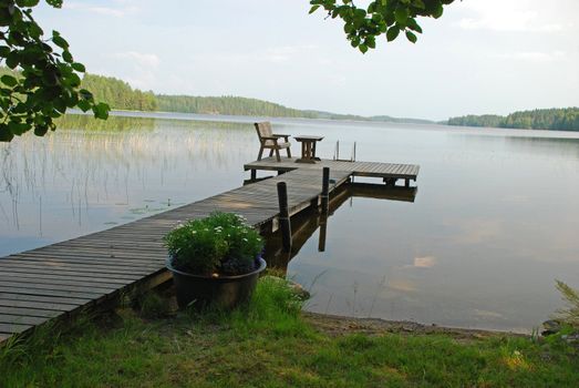 Wooden path in the border of a Lake, for the rest, fishing, swiming,  its very typical atribute of finnich lifestile in Central Finland, there are forests at the background