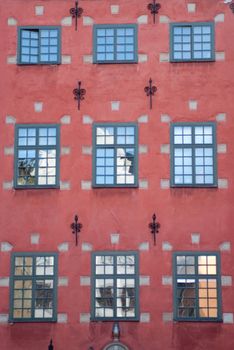 a red painted ancient house with an ornamented facade