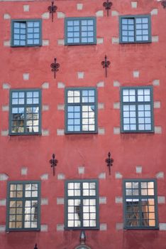 a red painted ancient house with an ornamented facade