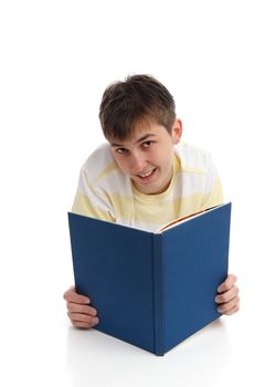 A happy boy reading a took or studying a textbook.  White background.
