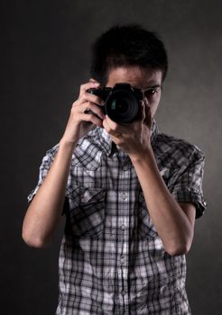 Asian man taking pictures with a slr camera