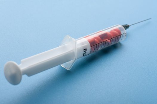 object on blue - medical Tablet and syringe