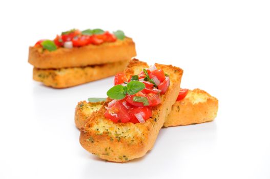 Bruschetta with tomato and fresh herbs on a white background.