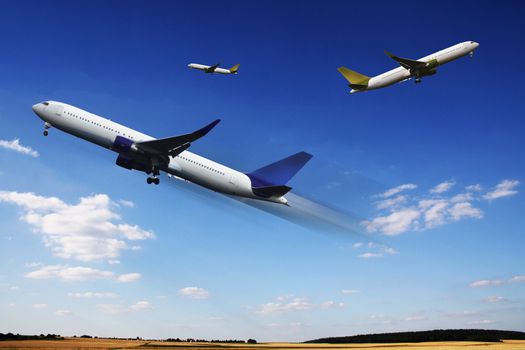 Aircraft in flight over the blue clouds