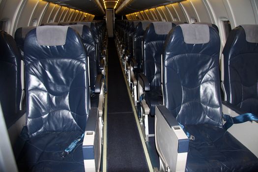 Inside of a commercial airplane with empty seats