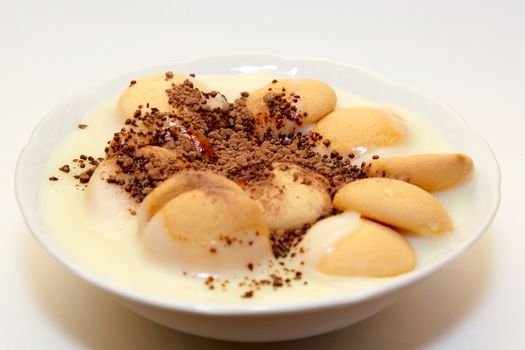 pudding with biscuit and granulation cacao on white