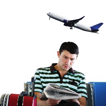 Man reading newspaper at the airport in the sitting